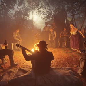 The Van der Linde gang sits by the fire.